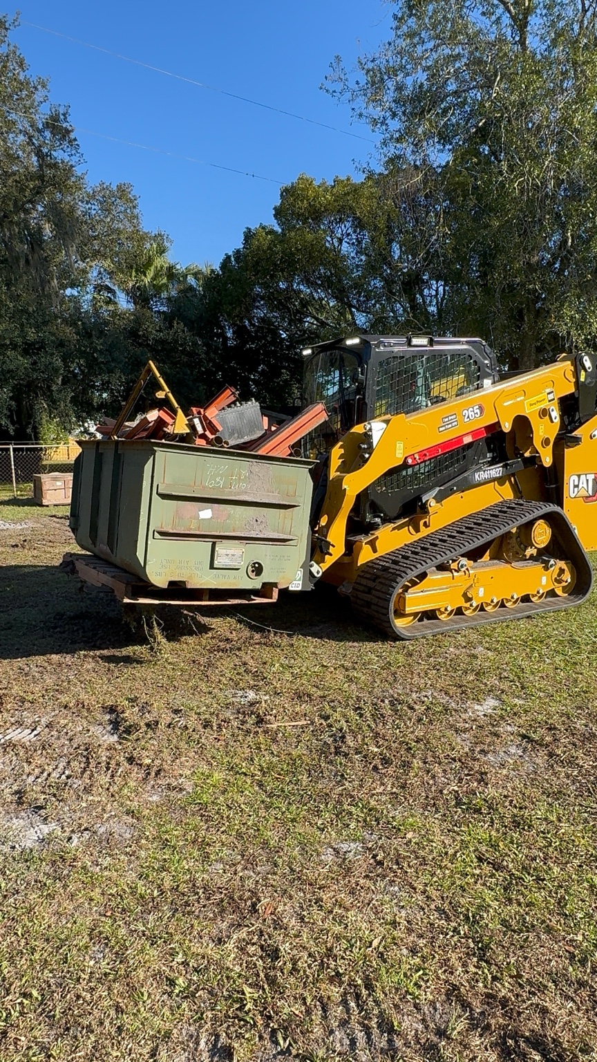 Loader moving a full scrap container