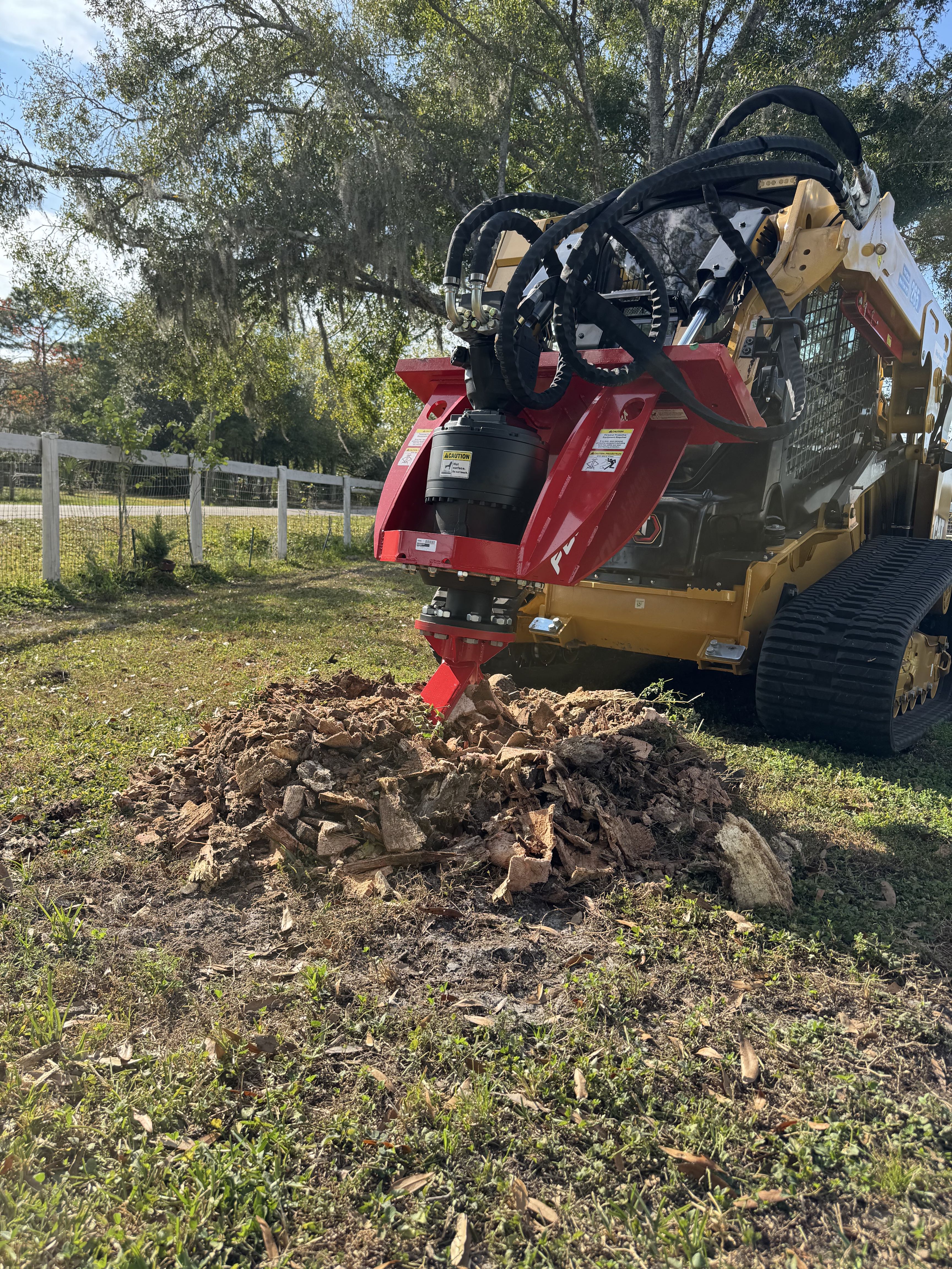Stump grinder attachment working on a stump